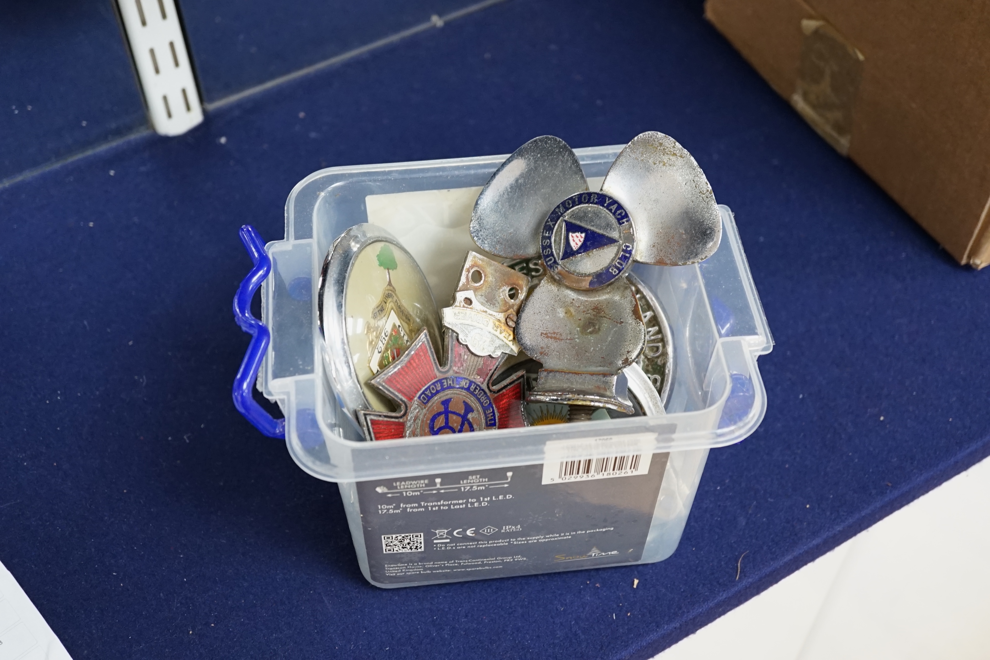 A group of assorted car badges